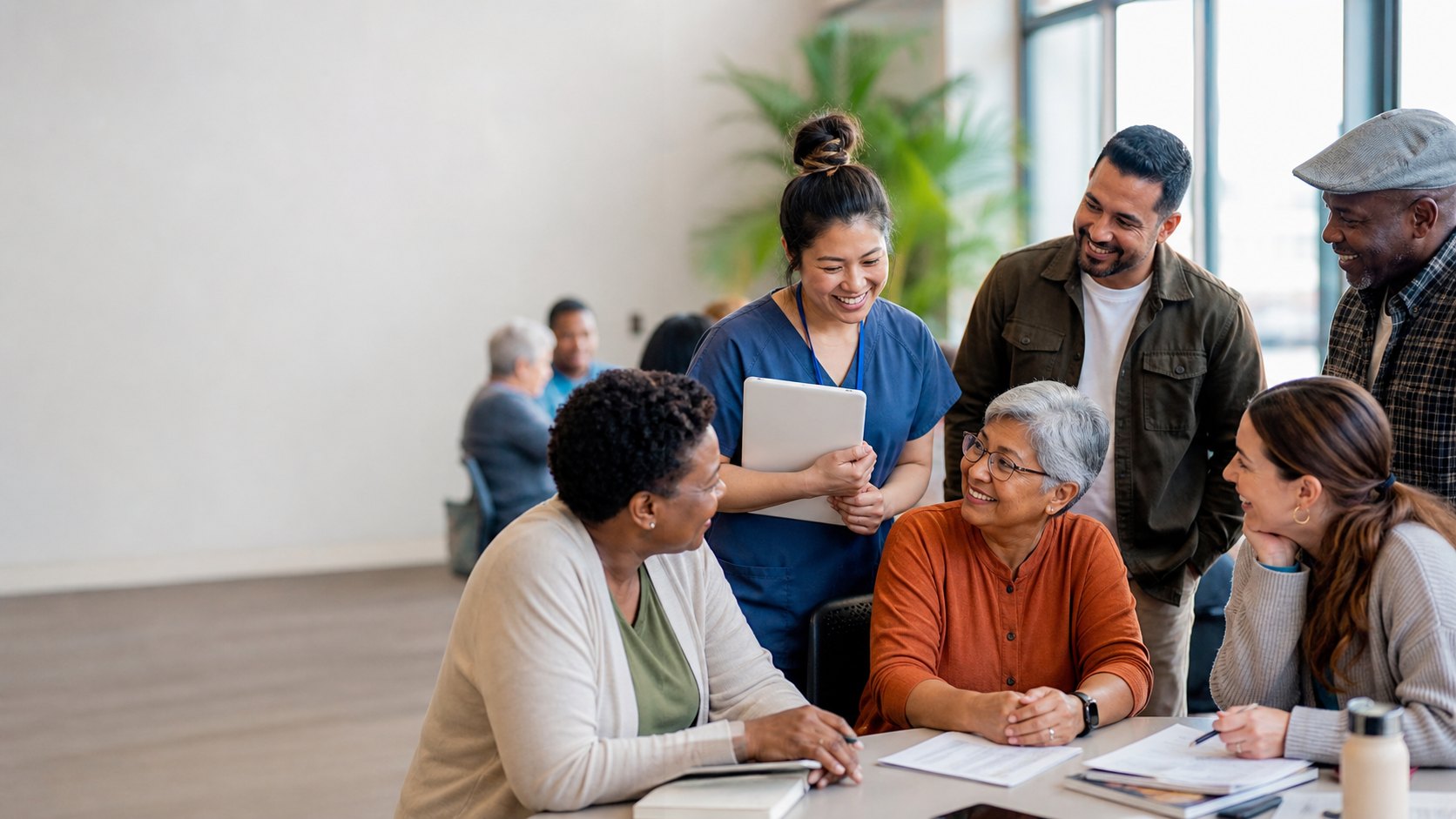 A diverse group of adult learners gathers after a community health workshop.